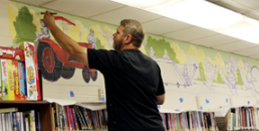 Artist Greg Preslicka paints  murals at Fulda Memorial Library