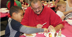 Students and parents join together to create gingerbread houses